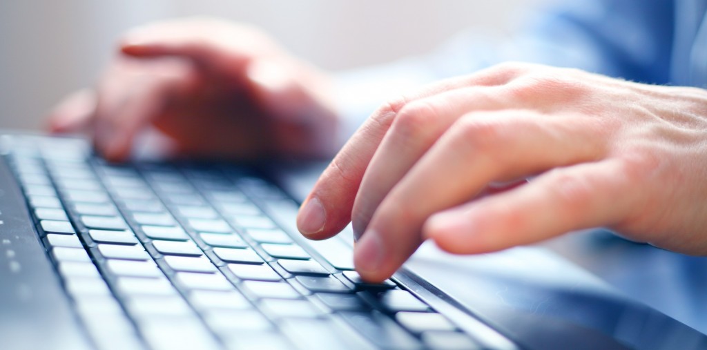 image of a client using our services in hampshire typing on a keyboard